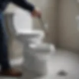 Professional plumber using a toilet auger to clear a clog