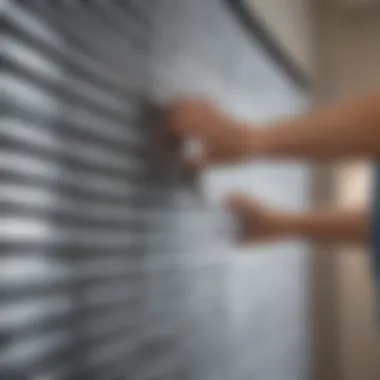 Person using a microfiber cloth to wipe down metal blinds